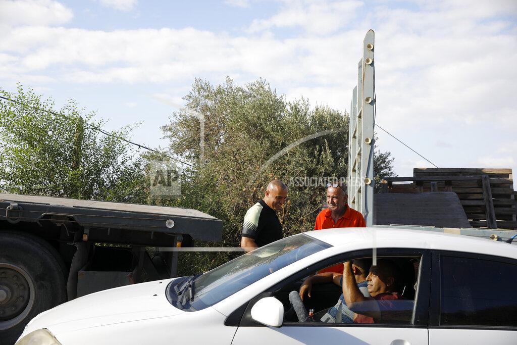 Ariel Schalit Locals gather near Palestinian fugitive Zakaria Zubeidi's hideouts in Umm al-Ghanam, northern Israel, Saturday, Sept. 11, 2021. Following Zubeidi's arrest, police said they have caught four of six Palestinians who broke out of a maximum-security prison early this week. (AP Photo/Ariel Schalit)