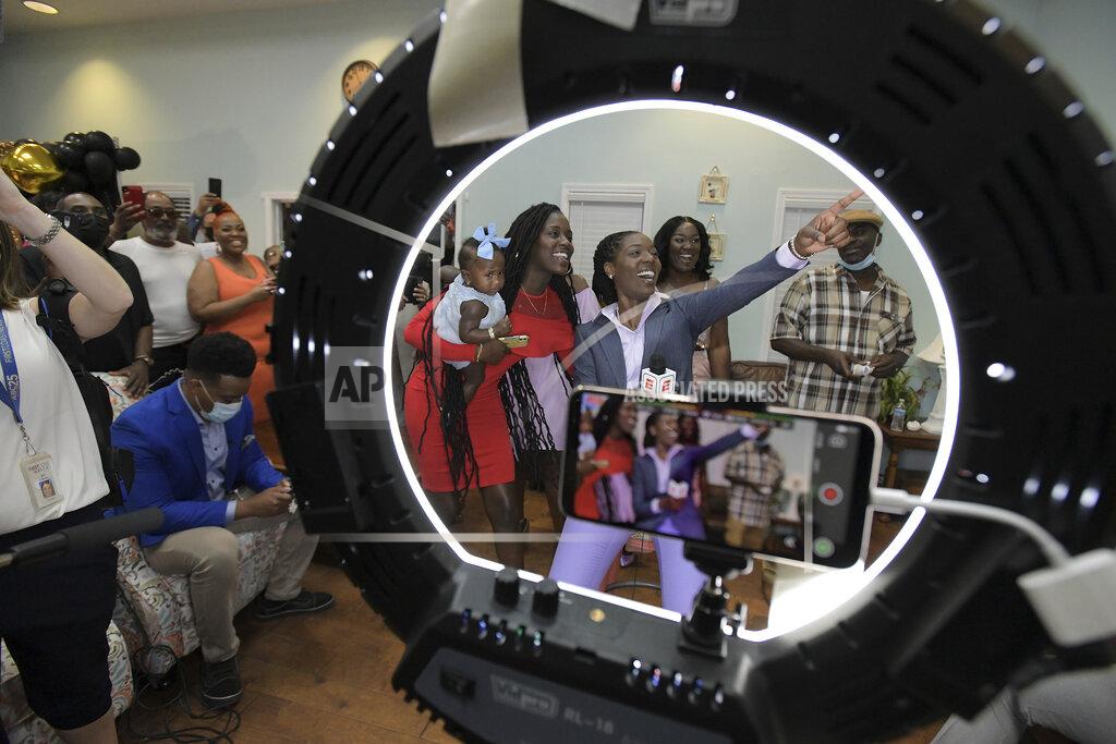 Bob Self Rennia Davis reacts to seeing replays of herself on television after Davis was chosen by the Minnesota Lynx with the ninth pick of the WNBA basketball draft, Thursday, April 15, 2021, in Jacksonville, Fla. (Bob Self/The Florida Times-Union via AP)