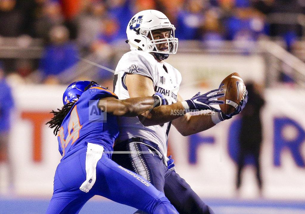 Steve Conner Utah State tight end Dax Raymond (87) reaches up to catch the ball as Boise State cornerback Tyler Horton (14) makes a tackle attempt in the second half of an NCAA college football game, Saturday, Nov. 24, 2018, in Boise, Idaho. Boise State won 33-24. (AP Photo/Steve Conner)