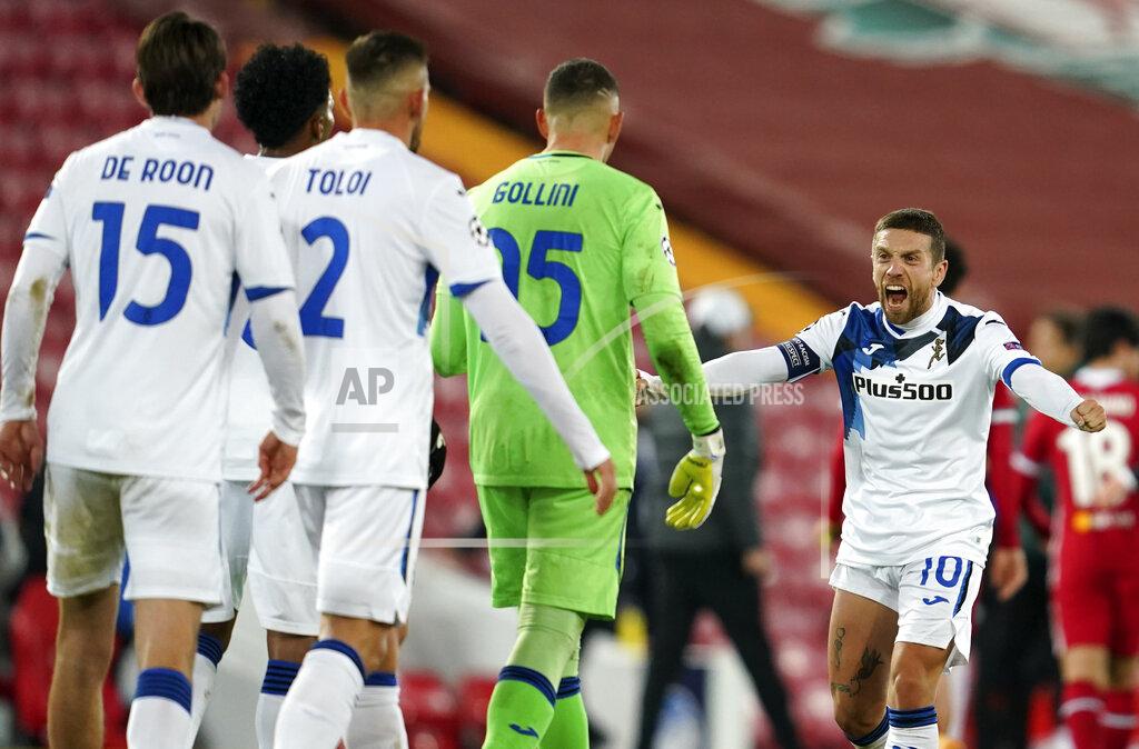Jon Super Atalanta's Papu Gomez, right, celebrates with teammates following the Champions League group D soccer match between Liverpool and Atalanta at Anfield stadium in Liverpool, England, Wednesday, Nov. 25, 2020. (AP Photo/Jon Super, Pool)