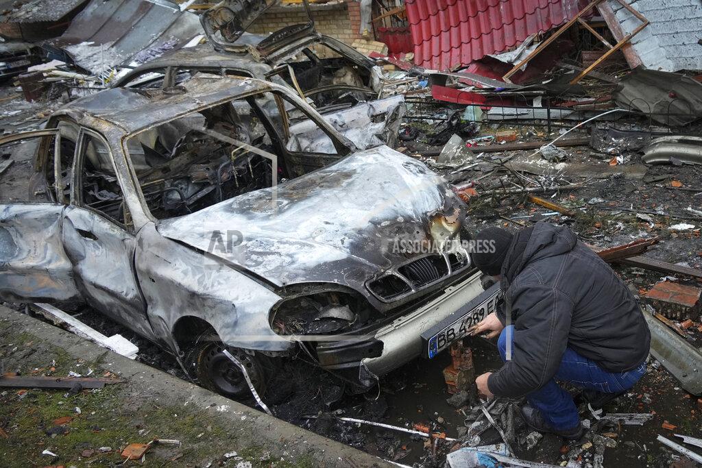 Efrem Lukatsky A man inspects his car damaged during Russian shelling in the town of Vyshgorod outside the capital Kiev, Ukraine, Thursday, Nov. 24, 2022. About 70% of the Ukrainian capital was left without power on Thursday morning after Moscow unleashed yet another devastating missile barrage on Ukraine's energy infrastructure, Kyiv's mayor said. (AP Photo/Efrem Lukatsky)