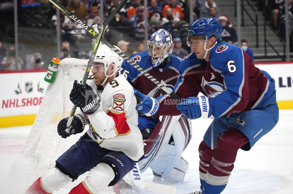 David Zalubowski Florida Panthers center Sam Bennett, left, crosses sticks with Colorado Avalanche defenseman Erik Johnson as they pursue the puck in the second period of an NHL hockey game Sunday, Dec. 12, 2021, in Denver. (AP Photo/David Zalubowski)