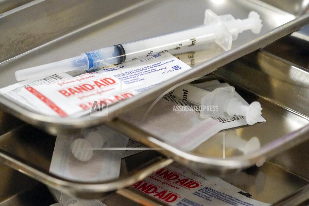 FILE - In this Thursday, March 18, 2021 file photo, syringes are filled with the Moderna COVID-19 vaccine at a pop up site in New York. On Friday, March 18, 2021, The Associated Press reported on stories circulating online incorrectly asserting that COVID-19 vaccines contain aluminum, a toxic ingredient that enters the brain and causes disease. The COVID-19 vaccines that have been authorized for emergency use in the United States do not contain any aluminum, according to their ingredient lists. Nor do the AstraZeneca or Sputnik V vaccines. Some Chinese COVID-19 vaccines, as well as some vaccines used against other diseases, do use tiny amounts of aluminum to help boost the immune response. This method is safe and the quantity of aluminum is trivial compared to what humans encounter elsewhere in everyday life, experts say. Aluminum has been used in vaccines since the 1930s as an adjuvant, or immune booster, according to the Centers for Disease Control and Prevention. (AP Photo/Mary Altaffer)