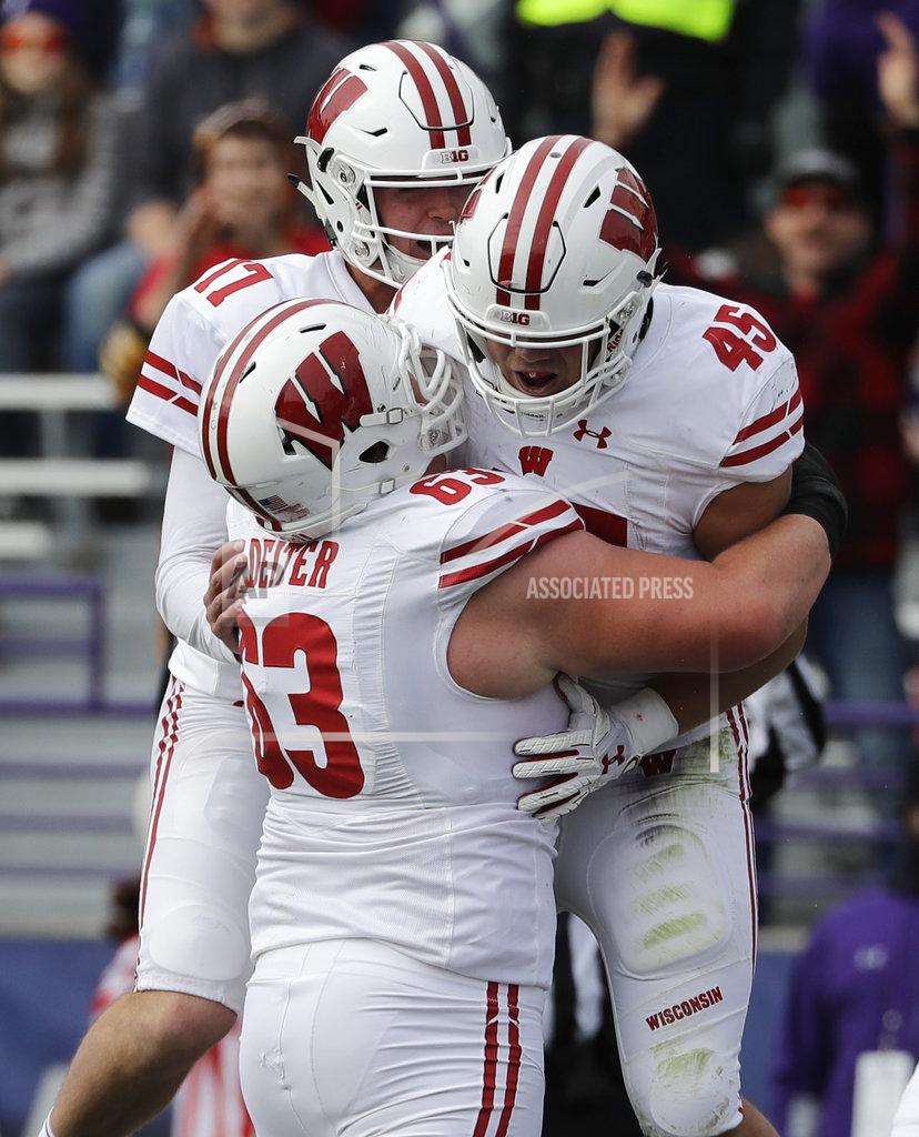 Nam Y. Huh Wisconsin fullback Alec Ingold (45) celebrates with left guard Michael Deiter (63) and quarterback Jack Coan (17) after scoring a touchdown against Northwestern during the first half of an NCAA college football game in Evanston, Ill., Saturday, Oct. 27, 2018. (AP Photo/Nam Y. Huh)
