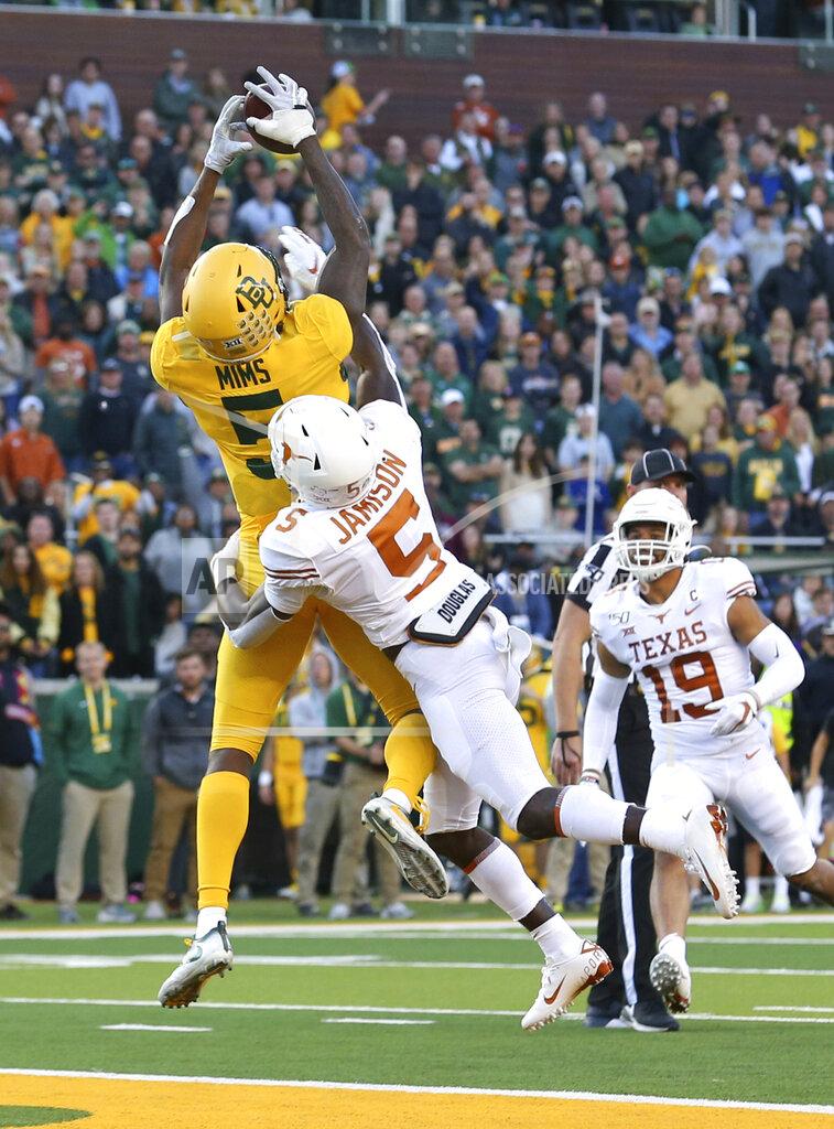 Richard W. Rodriguez Baylor wide receiver Denzel Mims (5) makes a touchdown reception over Texas defensive back D'Shawn Jamison (5) in the third quarter in an NCAA college football game Saturday, Nov. 23, 2019, in Waco, Texas. (AP Photo/Richard W. Rodriguez)