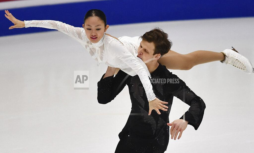Sergei Stepanov Audrey Lu and Misha Mitrofanov of USA perform in the pair's free skating program during the ISU Four Continents Figure Skating Championships in Tallinn, Estonia, Saturday, Jan. 22, 2022. (AP Photo/Sergei Stepanov)
