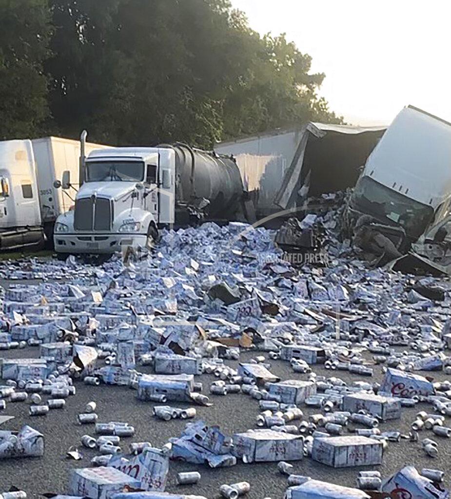 Uncredited In this photo provided by Florida Highway Patrol, cases of Coors Light beer are strewn across a highway after two semitrailers collided on a Florida highway on Wednesday, Sept. 21, 2022, near Brooksville, Fla. (Florida Highway Patrol via AP)