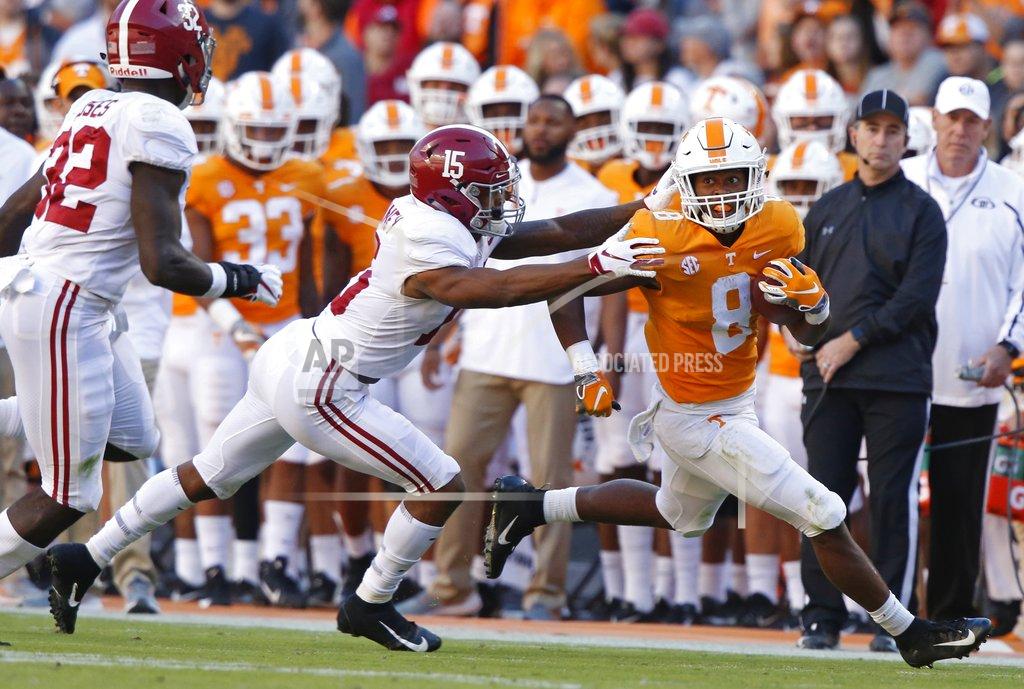 Wade Payne Tennessee running back Ty Chandler (8) runs for yardage as he's grabbed by Alabama defensive back Xavier McKinney (15) in the first half of an NCAA college football game Saturday, Oct. 20, 2018, in Knoxville, Tenn. (AP Photo/Wade Payne)