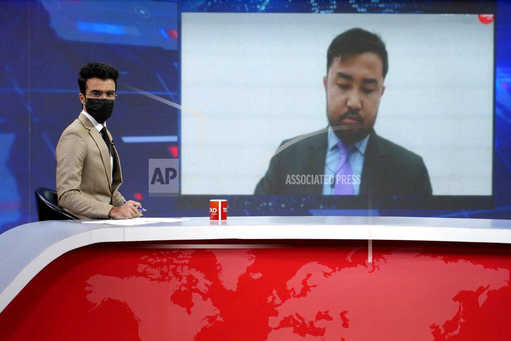 Ebrahim Noroozi TV anchor Hamed Bahram wears a face mask to protest the Taliban's new order that female presenters cover their faces, as he reads the news on TOLOnews, in Kabul, Afghanistan, Sunday, May 22, 2022. Afghanistan's Taliban rulers have begun enforcing an order requiring all female TV news anchors in the country to cover their faces while on-air. The move Sunday is part of a hard-line shift drawing condemnation from rights activists. (AP Photo/Ebrahim Noroozi)