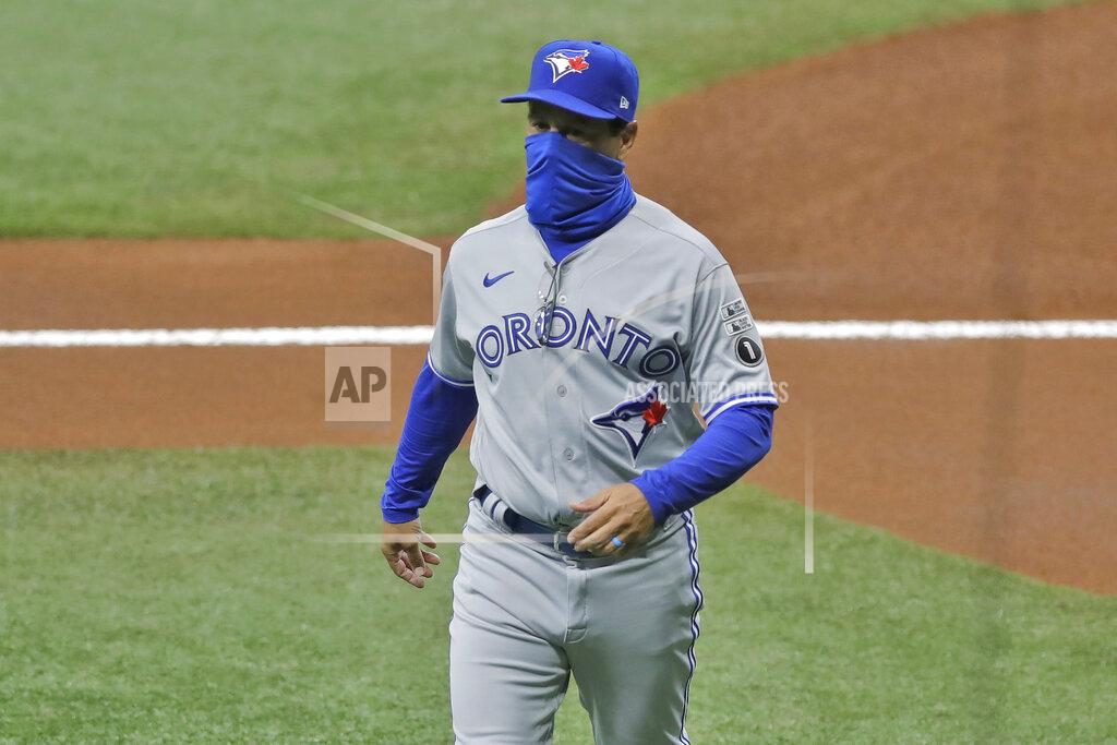 Chris O'meara Toronto Blue Jays manager Charlie Montoya wears a protective face mask as he walks back to the dugout after delivering the line up card before a baseball game against the Tampa Bay Rays Friday, July 24, 2020, in St. Petersburg, Fla. (AP Photo/Chris O'Meara)