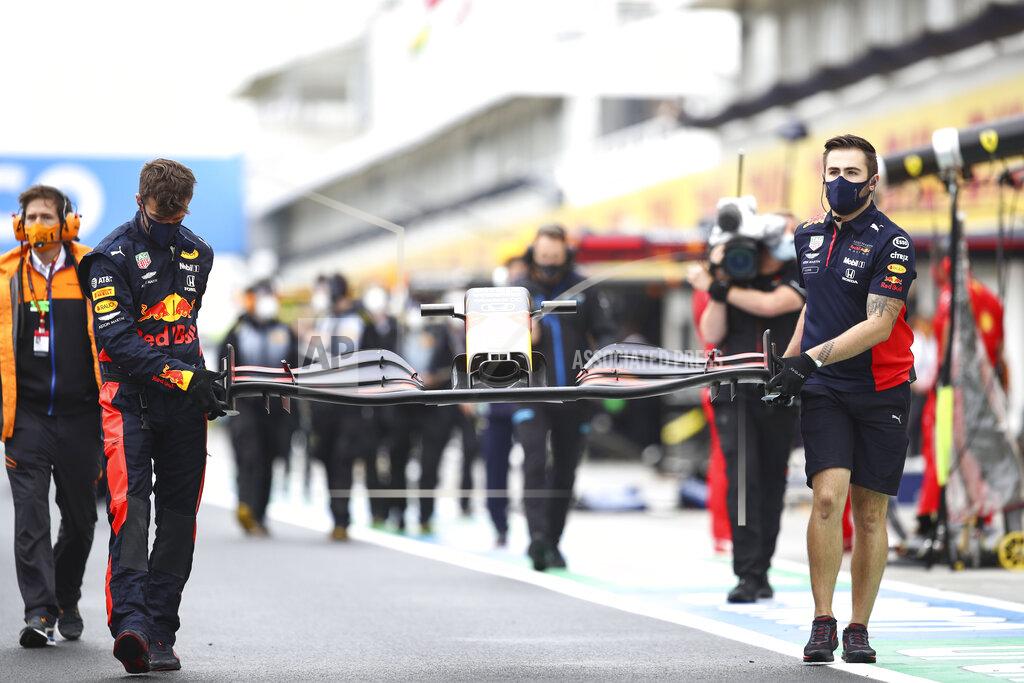 Mark Thompson Mechanics of Red Bull driver Max Verstappen of the Netherlands carry a front car piece prior the the Hungarian Formula One Grand Prix race at the Hungaroring racetrack in Mogyorod, Hungary, Sunday, July 19, 2020. (Mark Thompson/Pool via AP)