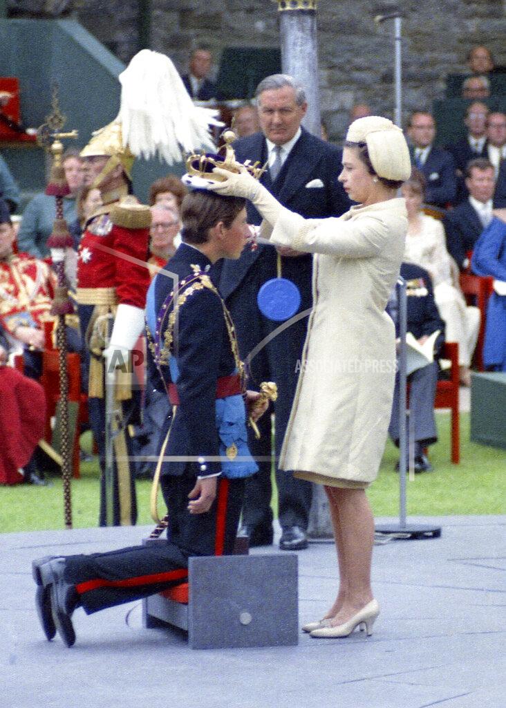 Uncredited FILE - Queen Elizabeth II crowns her son Charles, Prince of Wales during his investiture ceremony on July 1, 1969 at Caernafon Castle in Wales, as Britain's Home Secretary James Callaghan looks on. (AP Photo, File)