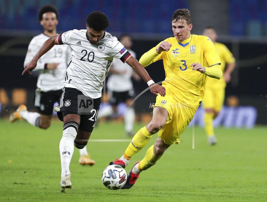 Michael Sohn Germany's Serge Gnabry, left, and Ukraine's Ilya Zabarnyi battle for the ball during the UEFA Nations League soccer match between Germany and the Ukraine at the Red Bull Arena in Leipzig, Germany, Saturday, Nov. 14, 2020. (AP Photo/Michael Sohn)