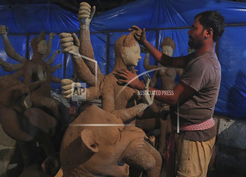 Mahesh Kumar A An artisan prepare a clay idol of Hindu Goddess Durga ahead of the Hindu religious festival season in Hyderabad, India, Wednesday, Oct. 7, 2020. The health ministry on Tuesday issued guidelines for large gatherings during the upcoming religious festival season and barred people from touching idols and holy books in such events to prevent the spread of infection. Health experts have warned the gatherings during the upcoming festivals have the potential for the virus to spread. (AP Photo/Mahesh Kumar A.)