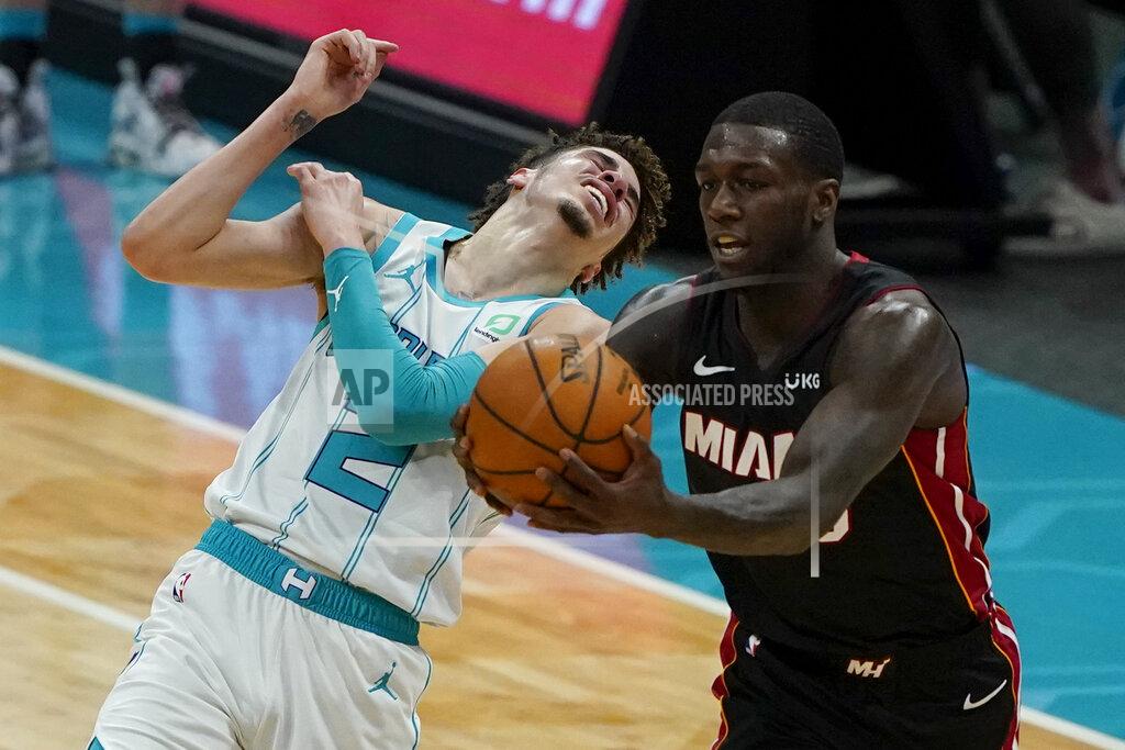 Chris Carlson Miami Heat guard Kendrick Nunn, right, pulls a pass away from Charlotte Hornets guard LaMelo Ball during the first half of an NBA basketball game on Sunday, May 2, 2021, in Charlotte, N.C. (AP Photo/Chris Carlson)