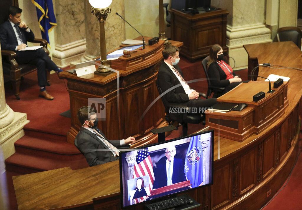 Wisconsin Gov. Tony Evers delivers his State of the State Address virtually as members of the Senate watch from the Senate Chambers at the Wisconsin State Capitol in Madison, Wis., Tuesday, Jan. 12, 2021. (Amber Arnold/Wisconsin State Journal via AP)