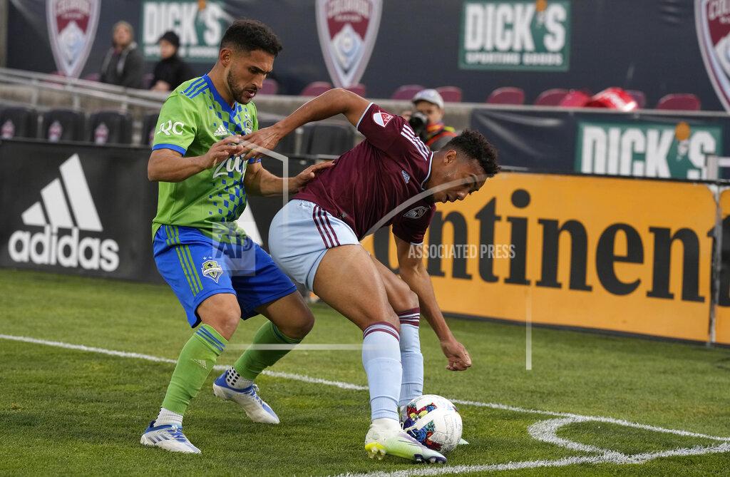 David Zalubowski Seattle Sounders midfielder Cristian Roldan, left, fights for control of the ball with Colorado Rapids forward Jonathan Lewis in the second half of an MLS soccer match Sunday, May 22 2022, in Commerce City, Colo. (AP Photo/David Zalubowski)