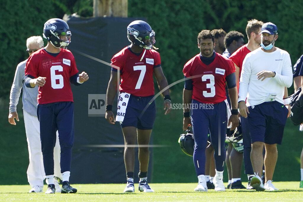 Seattle Seahawks quarterbacks Russell Wilson (3), Geno Smith (7) and Anthony Gordon (6) walk with offensive coordinator Brian Schottenheimer, right, and head coach Pete Carroll, left, following the last day of NFL football training camp, Thursday, Sept. 3, 2020, in Renton, Wash. (AP Photo/Ted S. Warren)