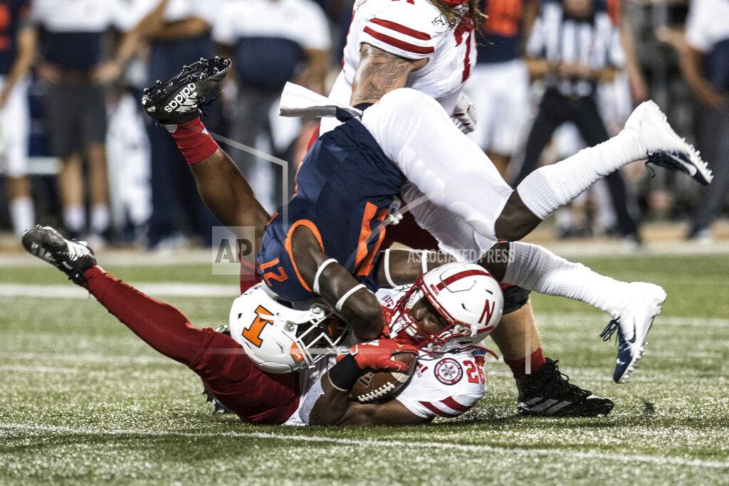 Holly Hart Nebraska's Dedrick Mills (26) is brought down by Illinois' Jartavius Martin (21) in the first half of an NCAA college football game, Saturday, Sept. 21, 2019, in Champaign, Ill. (AP Photo/Holly Hart)