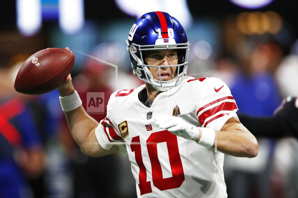 John Bazemore FILE- In this Oct. 22, 2018 file photo, New York Giants quarterback Eli Manning (10) works against the Atlanta Falcons during the first half of an NFL football game in Atlanta. This season Manning will enter his 16th training camp with the New York Giants. (AP Photo/John Bazemore)