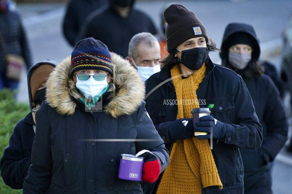 Voters wait in the morning cold for the polls to open to vote in the general election, Tuesday, Nov. 3, 2020, in Portland, Maine. (AP Photo/Robert F. Bukaty)