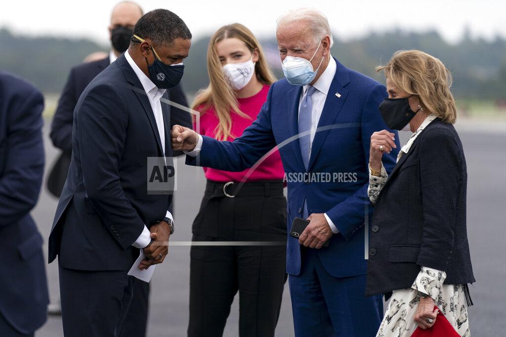 Andrew Harnik Democratic presidential candidate former Vice President Joe Biden greets Rep. Cedric Richmond, D-La., left, as he arrives with his granddaughter Finnegan Biden, center, and sister Valerie Biden, right, at Columbus Airport in Columbus, Ga., Tuesday, Oct. 27, 2020, to travel to Warm Springs, Ga. for a rally. (AP Photo/Andrew Harnik)