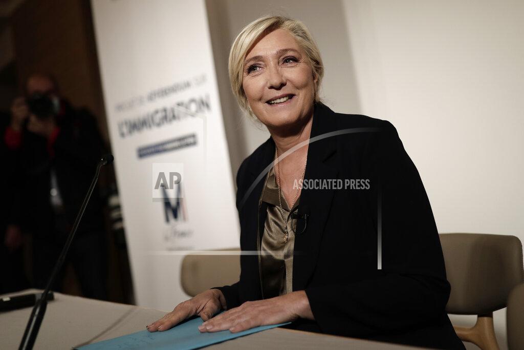 Lewis Joly Far-right leader Marine le Pen smiles before a press conference on immigration Tuesday, Sept. 28, 2021 in Paris. Presidential candidate for the 2022 election Marine Le Pen announced plans for an immigration referendum. (AP Photo/Lewis Joly))