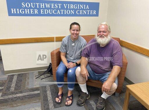 Ernest Ray, right, sits with his niece, Kendra Potter at the Virginia Higher Education Center in Abington Va., Tuesday Aug. 17, 2021. Ray has been fighting the state of Virginia in court as it tries to recoup unemployment benefits he received after being laid off from his job of more than two decades. (AP Photo/Sarah Rankin)