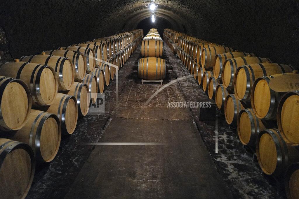 Francois Mori FILE - In this July 28, 2020 file photo, empty barrels for the next harvest in autumn in the cave of Champagne producer Anselme Selosse in Avize, in the Champagne region, east of Paris. Nation by nation, how is Election Day in the United States being watched, considered, assessed? A spat between the Trump administration and the European Union — and France, in particular — resulted in the US slapping 25% retaliatory tariffs on one of the EU's most emblematic products last year: French wine. (AP Photo/Francois Mori, File)