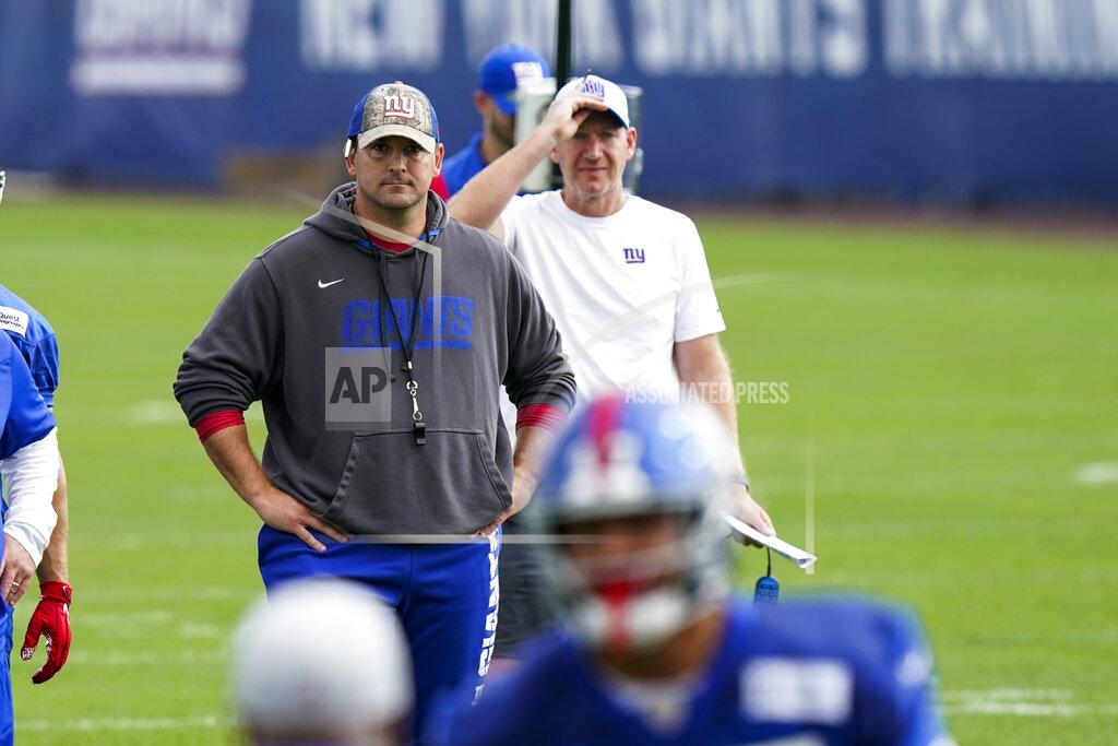 New York Giants head coach Joe Judge, background left, looks on at NFL football training camp, Wednesday, July 28, 2021, in East Rutherford, N.J. (AP Photo/Corey Sipkin)