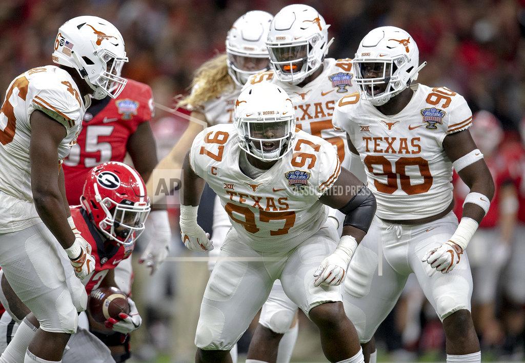 Nick Wagner Texas defensive lineman Chris Nelson (97) celebrates a stop against Georgia during the first half of the Sugar Bowl NCAA college football game Tuesday, Jan. 1, 2019, in New Orleans. (Nick Wagner/Austin American-Statesman via AP)