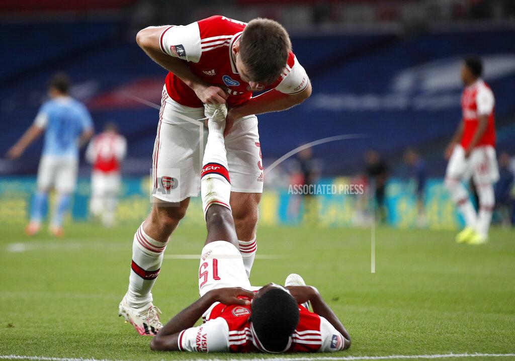 Matt Childs Arsenal's Kieran Tierney helps teammate Ainsley Maitland-Niles with cramp during the FA Cup semifinal soccer match between Arsenal and Manchester City at Wembley in London, England, Saturday, July 18, 2020. (AP Photo/Matt Childs,Pool)