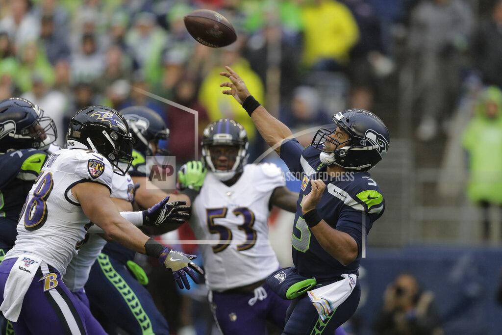 John Froschauer Seattle Seahawks quarterback Russell Wilson (3) passes under pressure from Baltimore Ravens linebacker L.J. Fort, left, during the first half of an NFL football game, Sunday, Oct. 20, 2019, in Seattle. (AP Photo/John Froschauer)