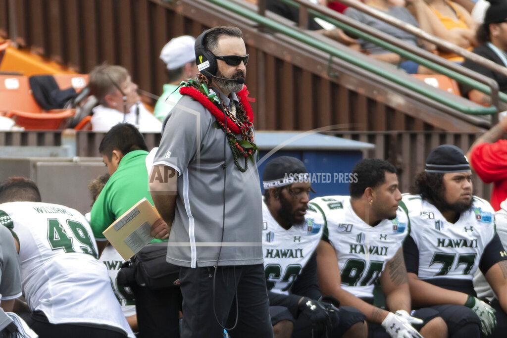 Eugene Tanner Hawaii coach Nick Rolovich watches during the first half of the team's Hawaii Bowl NCAA college football game against BYU, Tuesday, Dec. 24, 2019, in Honolulu. (AP Photo/Eugene Tanner)