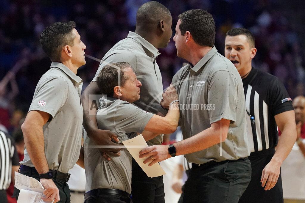 Sue Ogrocki Arkansas head coach Eric Musselman is held back from the officials after being ejected in the second half of an NCAA college basketball game against Oklahoma, Saturday, Dec. 11, 2021, in Tulsa, Okla. (AP Photo/Sue Ogrocki)