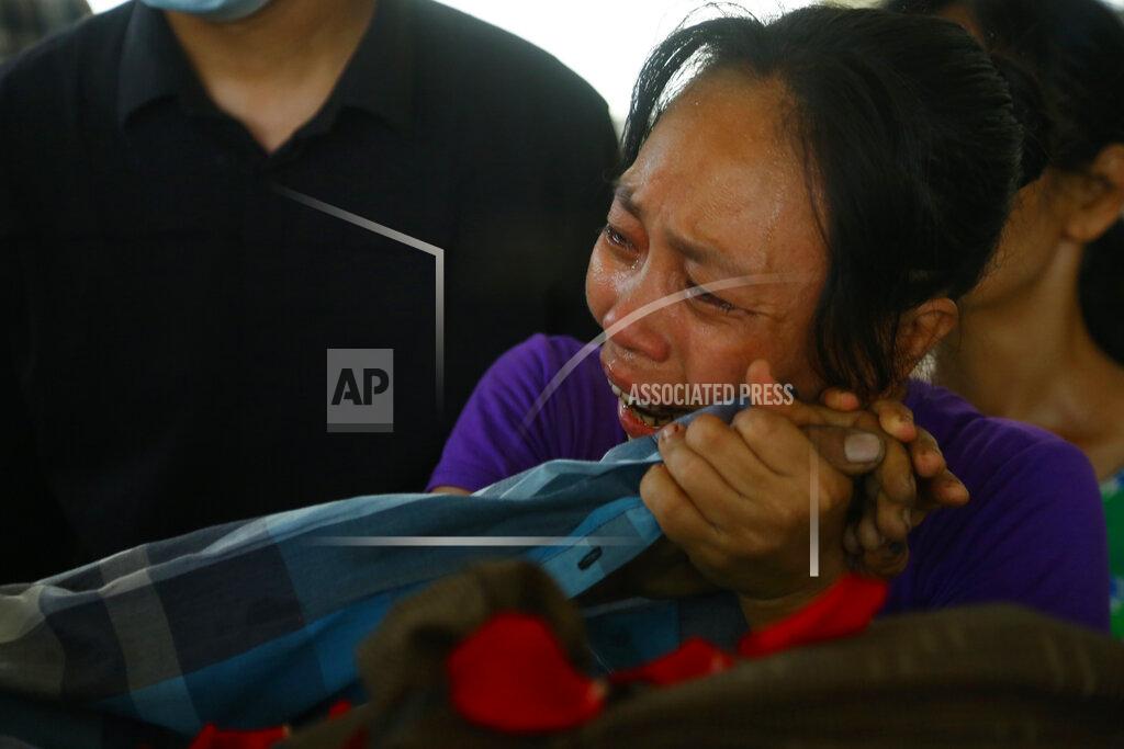 Uncredited A family member mourns over the death of Aung Myo Thant as they gather at his funeral in Yangon, Myanmar, Tuesday, March 30, 2021. Family members said Aung Myo Thant was killed Monday during a clash with security forces at a protest against the military's coup that ousted the government of Aung San Suu Kyi on Feb. 1. (AP Photo)