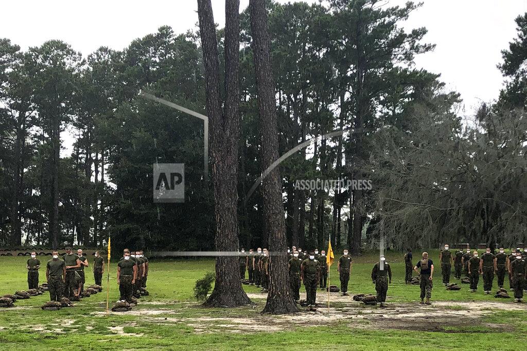FILE - In this May 27, 2020 file photo, Marine recruits line up at Parris Island Recruit Depot, S.C. A study published on Wednesday, Nov. 11, 2020 found that despite temperature and COVID-19 symptom checks and strict quarantines before they were allowed to start training, new Marine recruits spread the virus to others even though hardly any of them had symptoms. None of the infections that occurred were caught through symptom screening. (AP Photo/Lolita Baldor)