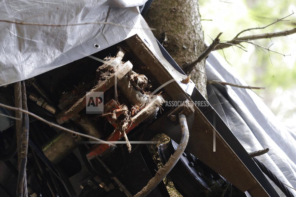 Luca Bruno A view of a clamp that was placed on an emergency brake, as search for evidence continues in the wreckage of a cable car after it collapsed near the summit of the Stresa-Mottarone line in the Piedmont region, northern Italy, Wednesday, May 26, 2021. Police have made three arrests in the cable car disaster that killed 14 people after an investigation showed a clamp, placed on the brake as a patchwork repair effort, prevented the brake from engaging after the lead cable snapped. (AP Photo/Luca Bruno)