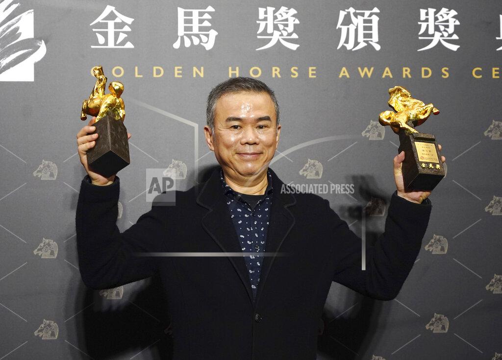 Billy Dai Taiwanese director Chen Yu-hsun holds his awards for Best Director and Best Original Screenplay at the 57th Golden Horse Awards in Taipei, Taiwan, Saturday, Nov. 21, 2020. Chen won for the film "My Missing Valentine" at this year's Golden Horse Awards - one of the Chinese-language film industry's biggest annual events. (AP Photo/Billy Dai)