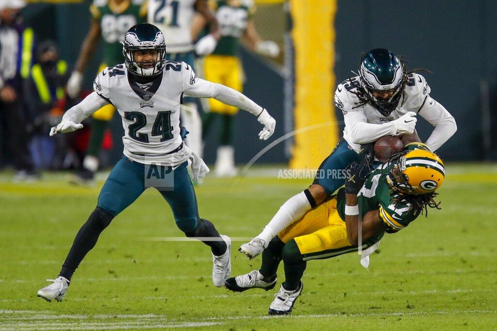 Matt Ludtke Green Bay Packers' Davante Adams catches a pass with Philadelphia Eagles' Avonte Maddox and Darius Slay (24) defending during the second half of an NFL football game Sunday, Dec. 6, 2020, in Green Bay, Wis. (AP Photo/Matt Ludtke)