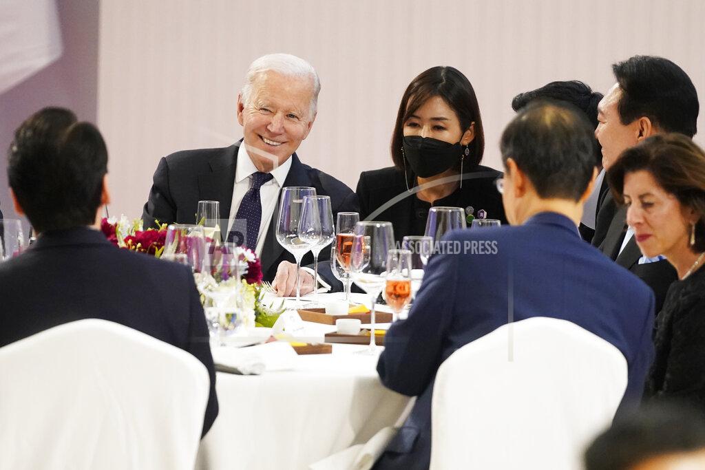 Evan Vucci U.S. President Joe Biden, back left, shares a light moment with people at a table with South Korean President Yoon Suk Yeol, back right, at a state dinner at the National Museum of Korea, Saturday, May 21, 2022, in Seoul. (AP Photo/Evan Vucci)