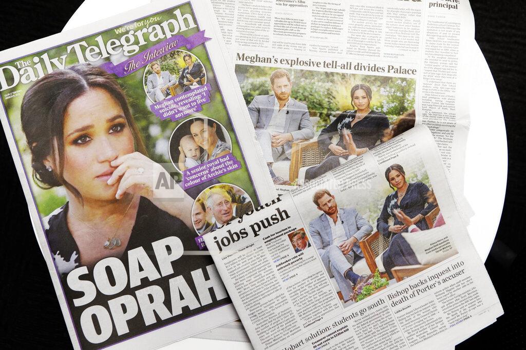 Rick Rycroft Australian newspapers report in Sydney, Tuesday, March 9, 2021, on an interview of The Duke and Duchess of Sussex by Oprah Winfrey. (AP Photo/Rick Rycroft)