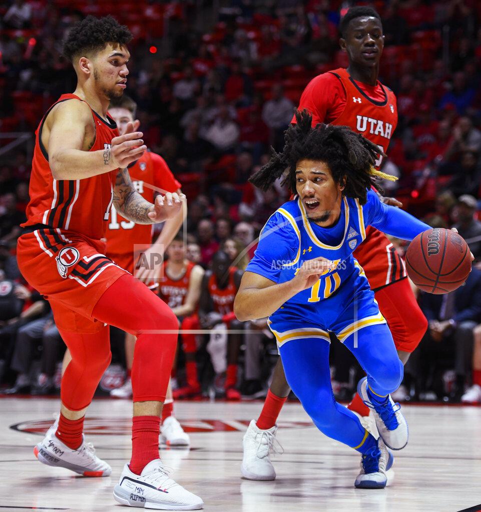Alex Goodlett UCLA guard Tyger Campbell drives between Utah forward Timmy Allen, left, and center Lahat Thioune, right rear, during the first half of an NCAA college basketball game Thursday, Feb. 20, 2020, in Salt Lake City. (AP Photo/Alex Goodlett)
