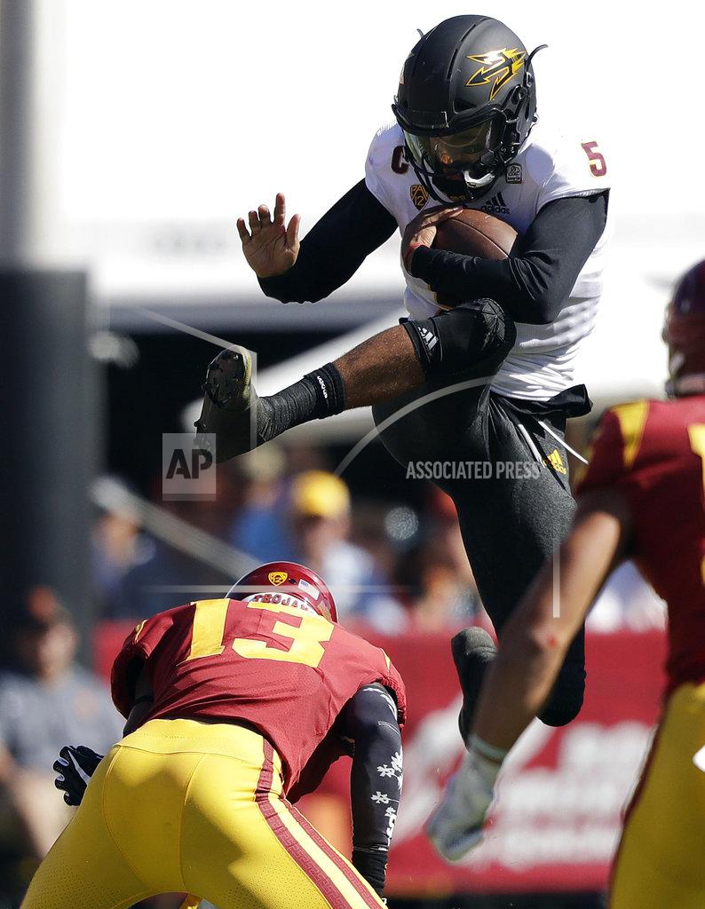 Marcio Jose Sanchez Arizona State quarterback Manny Wilkins, top, leaps over Southern California linebacker Levi Jones (13) during the first half of an NCAA college football game Saturday, Oct. 27, 2018, in Los Angeles. (AP Photo/Marcio Jose Sanchez)