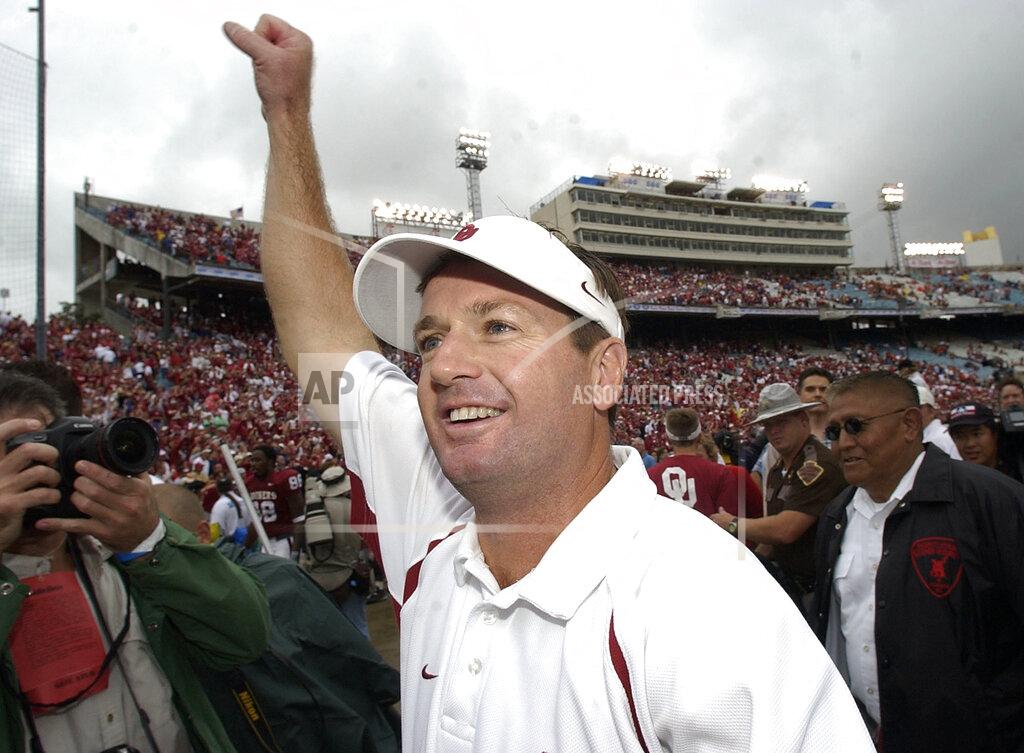 Tony Gutierrez FILE - In this Oct. 9, 2004, file photo, Oklahoma coach Bob Stoops celebrates the Sooners 12-0 win over Texas, in Dallas. The annual Texas-Oklahoma rivalry game in Dallas decided the Big 12 more often than not. Both teams were nationally ranked in nine of the ten meetings. Oklahoma won the first five from 2000-04 but Texas bounced back by winning four of the last five. (AP Photo/Tony Gutierrez, File)