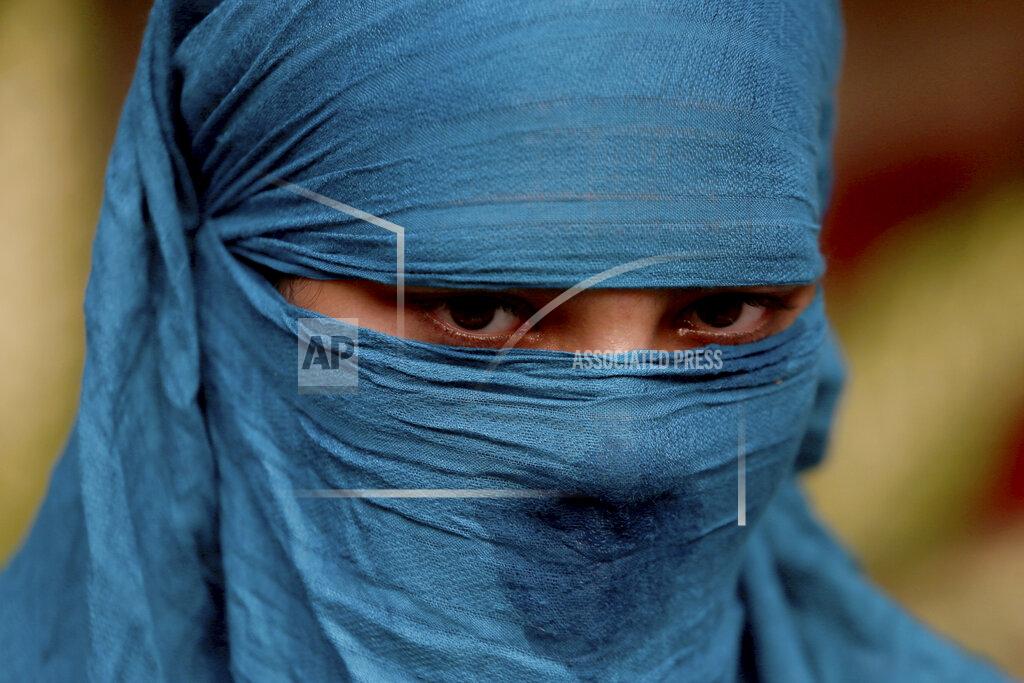 Fareed Khan Neha, 15, who was married as a child, weeps during an interview in Karachi, Pakistan, on Wednesday, Nov. 11, 2020. Neha said she was tricked into marriage by a favorite aunt. Instead of going to a hospital to visit a relative, she was taken to the home of her aunt’s in-laws and told she would marry her aunt’s 45-year-old brother-in-law. “I told her I can’t, I am too young and I don’t want to. He is old,” Neha said. “She slapped me and locked me up in a room.” (AP Photo/Fareed Khan)