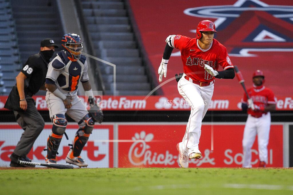 Mark J. Terrill Los Angeles Angels' Shohei Ohtani, right, runs to first as he grounds out while Houston Astros catcher Martin Maldonado, center, and home plate umpire Cory Blaser watch during the third inning of a baseball game Friday, July 31, 2020, in Anaheim, Calif. (AP Photo/Mark J. Terrill)