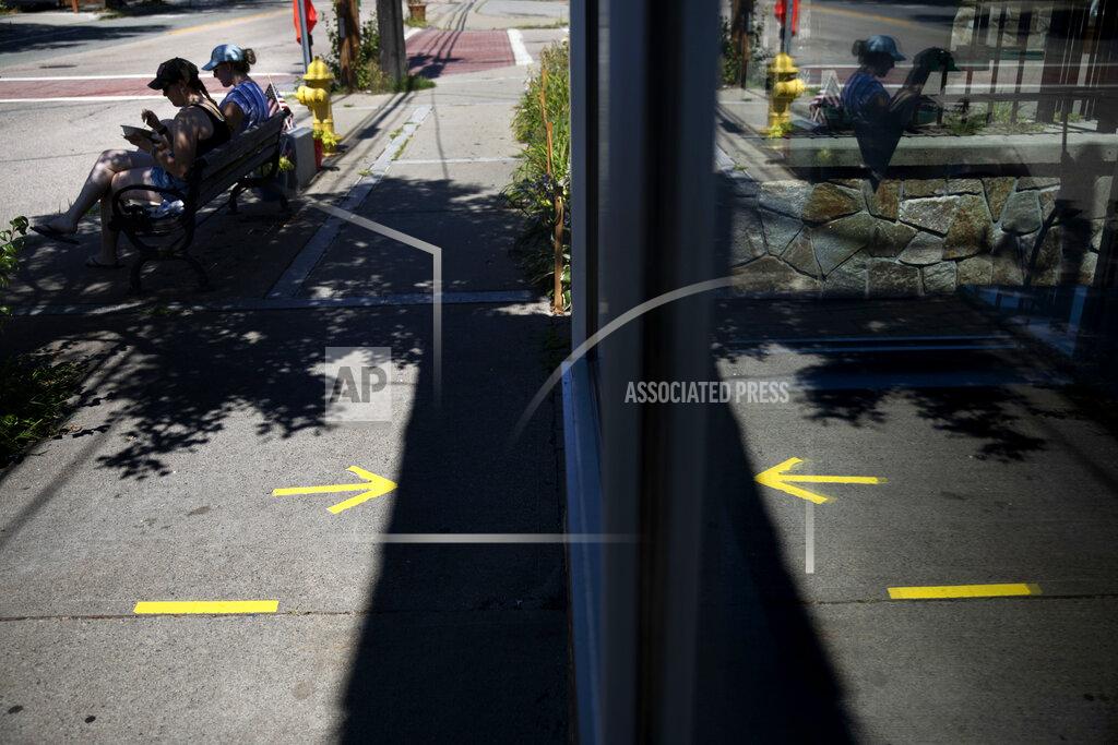 David Goldman Tape marks social distance spots for customers outside one of two Brickley's Ice Cream shops which closed for the season after teenage workers were harassed by customers who refused to wear a mask or socially distance, in Wakefield, R.I., Wednesday, July 29, 2020. Disputes over masks and mask mandates are playing out at businesses, on public transportation and in public places across America and other nations. (AP Photo/David Goldman)