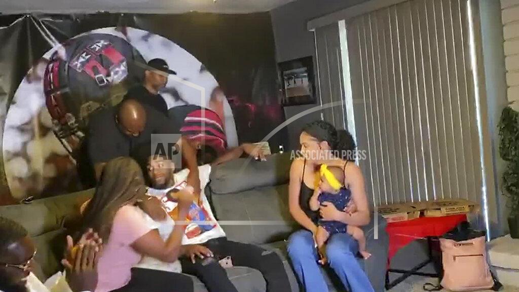 Uncredited In this still image from video provided by the NFL, Jaylon Johnson, seated in center, receives congratulations after being selected by the Chicago Bears in the second round of the NFL football draft, Friday, April 24, 2020. (NFL via AP)