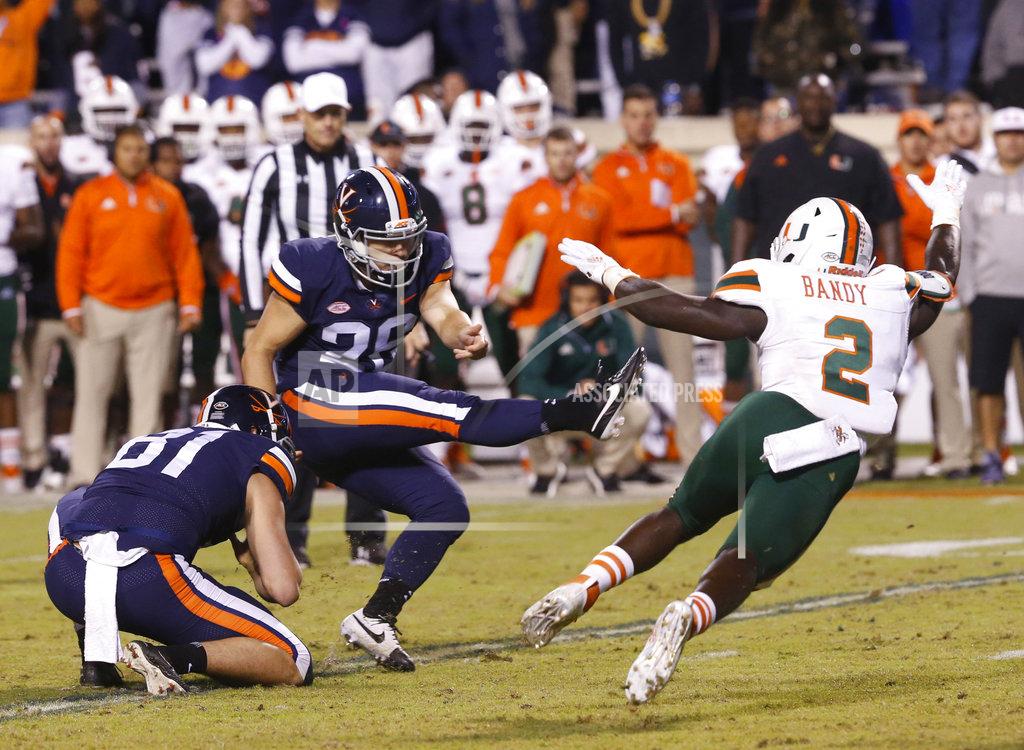 Steve Helber Virginia place kicker Brian Delaney (26) kicks a field goal as Miami defensive back Trajan Bandy (2) tries to block during the second half of an NCAA college football game in Charlottesville, Va., Saturday, Oct. 13, 2018. Bandy ran into Delaney causing a roughing the kicker penalty. Virginia defeated Miami 16-13. (AP Photo/Steve Helber)